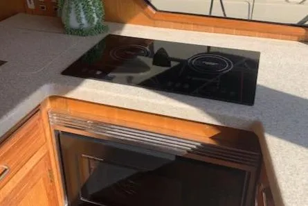 Slide: The Image of 1986 Ocean Alexander 39 Sedan kitchen with stovetop and microwave. - 28