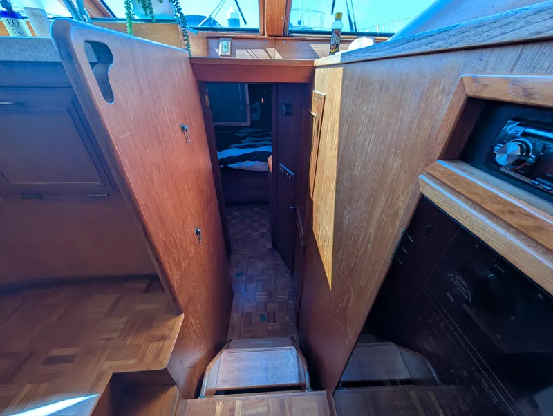 Slide: The Image of Interior view of 1986 Ocean Alexander 39 Sedan, showcasing wooden cabinetry and narrow passageway. - 30