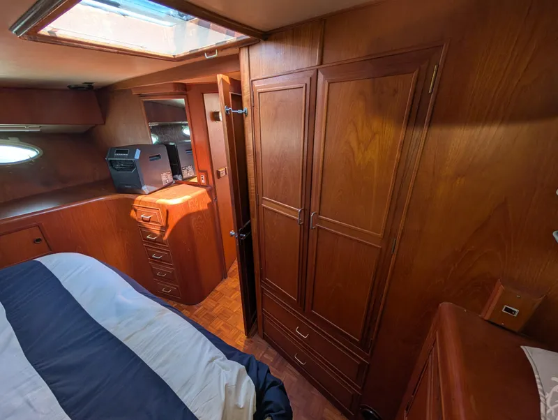 Slide: The Image of 1986 Ocean Alexander 39 Sedan interior with wood cabinetry and bed, showcasing classic yacht design. - 36