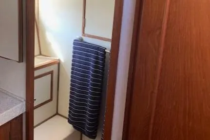 Slide: The Image of 1986 Ocean Alexander 39 Sedan bathroom with wooden accents and striped towel. - 37