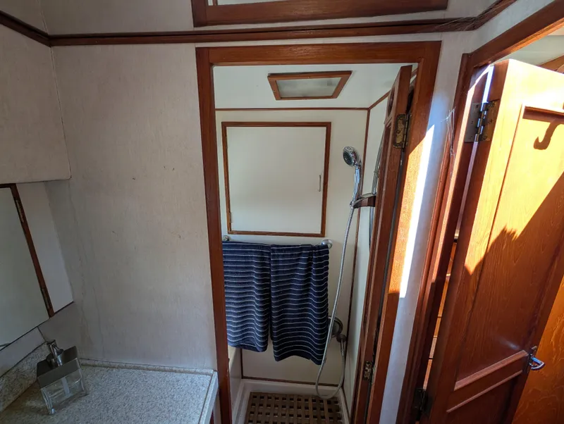 Slide: The Image of Bathroom interior of 1986 Ocean Alexander 39 Sedan yacht with shower and wooden accents. - 38