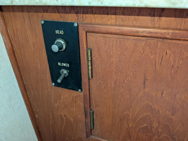 Slide: The Image of Control panel on 1986 Ocean Alexander 39 Sedan yacht, featuring head and blower switches. - 43