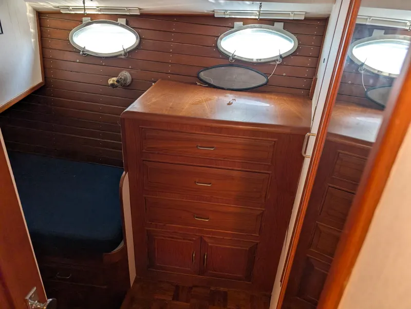 Slide: The Image of 1986 Ocean Alexander 39 Sedan interior with wooden cabinetry and portholes. - 44
