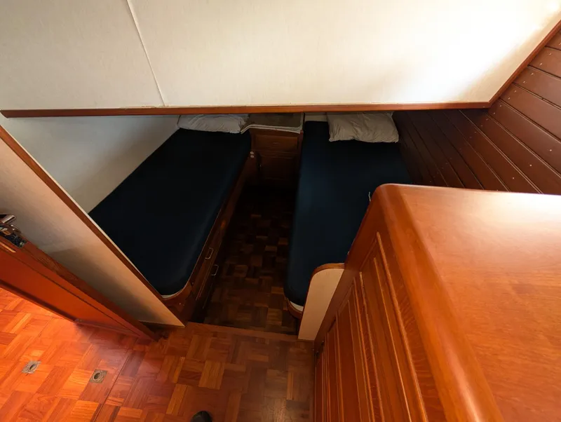 Slide: The Image of 1986 Ocean Alexander 39 Sedan cabin with twin beds and wooden interior. - 46