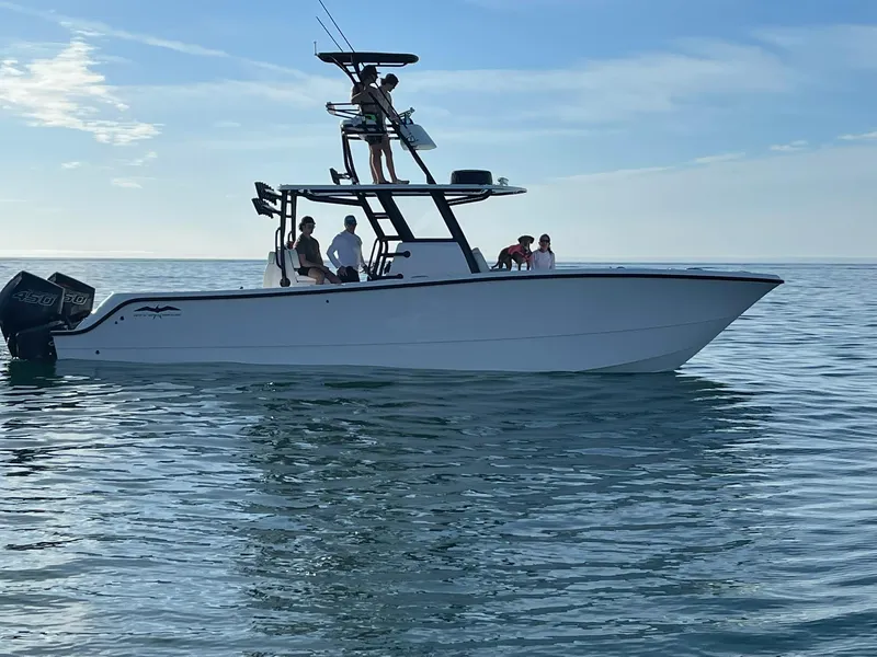 The Image of 2023 Invincible 33 Catamaran on calm water with passengers enjoying the ride. - 1