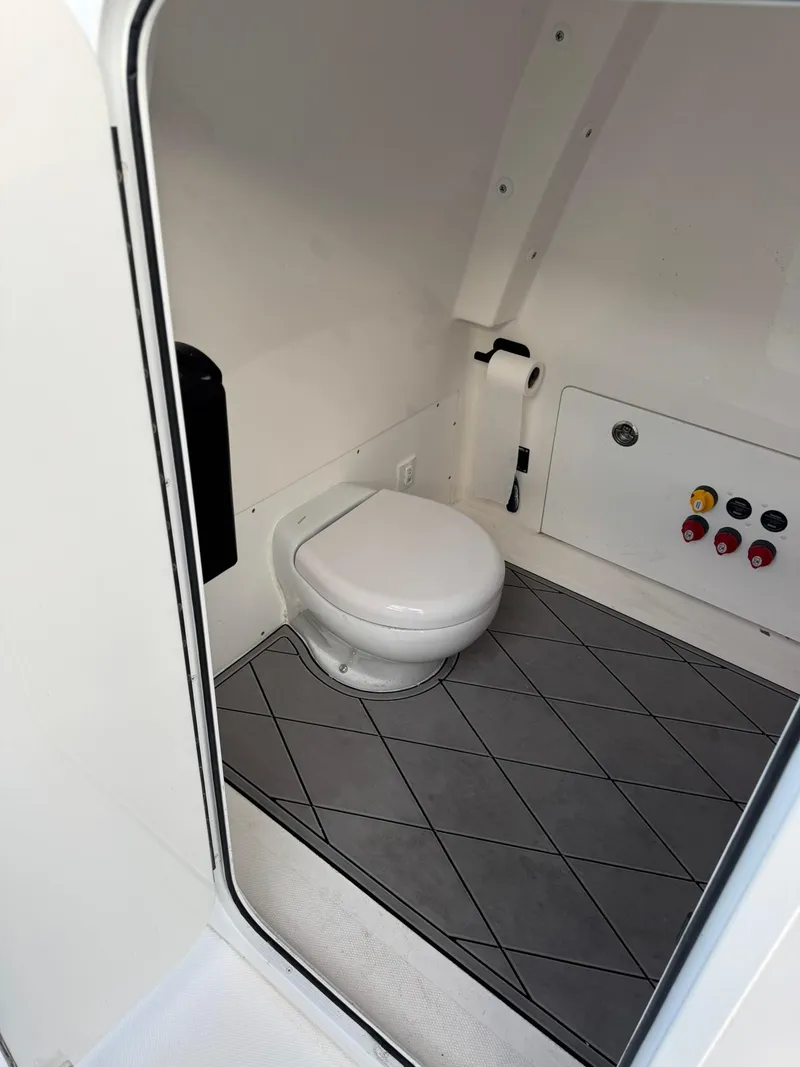 Slide: The Image of 2023 Invincible 33 Catamaran interior with modern marine toilet and control panel. - 13
