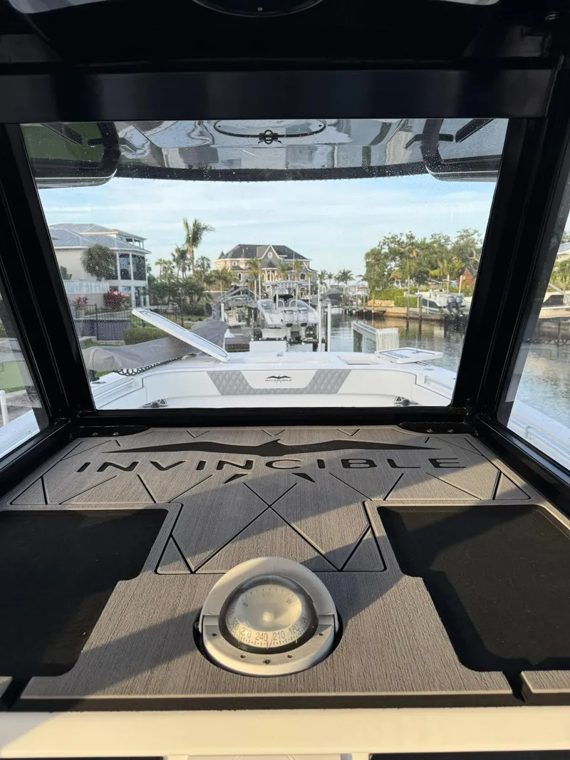Slide: The Image of 2023 Invincible 33 Catamaran interior view with waterfront background. - 14