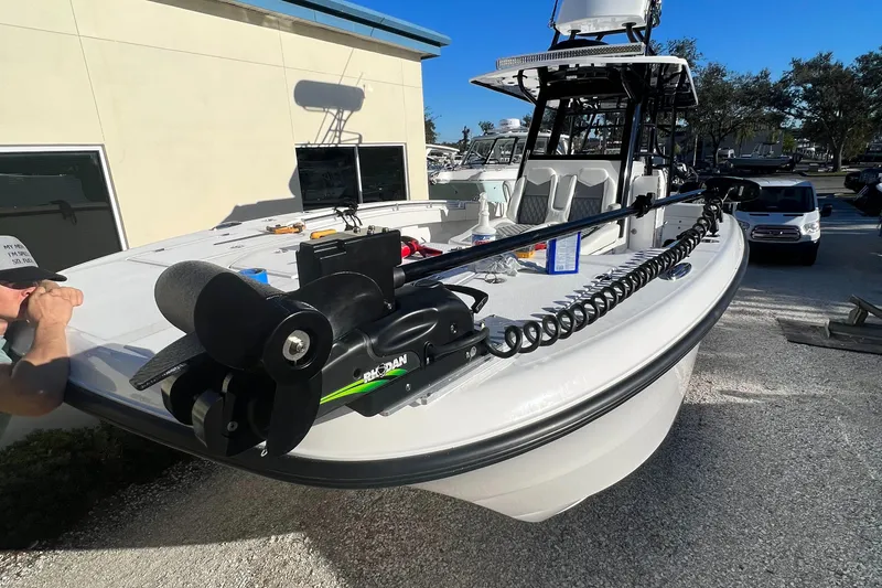 Slide: The Image of 2023 Invincible 33 Catamaran with advanced trolling motor, docked outdoors. - 15