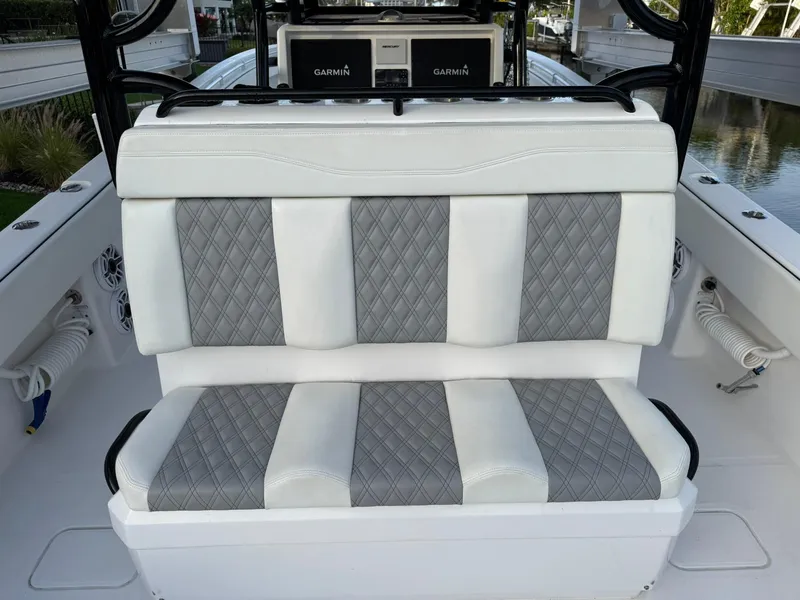 Slide: The Image of 2023 Invincible 33 Catamaran interior with diamond-stitched seating and Garmin electronics. - 5