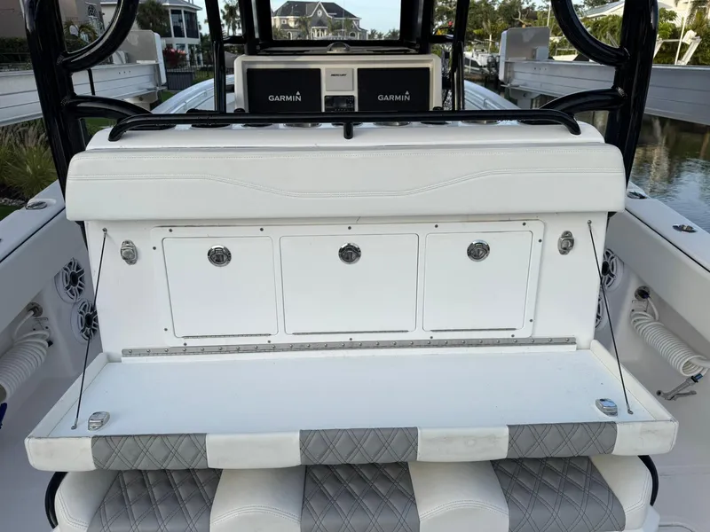 Slide: The Image of 2023 Invincible 33 Catamaran interior with white seating and storage compartments. - 6