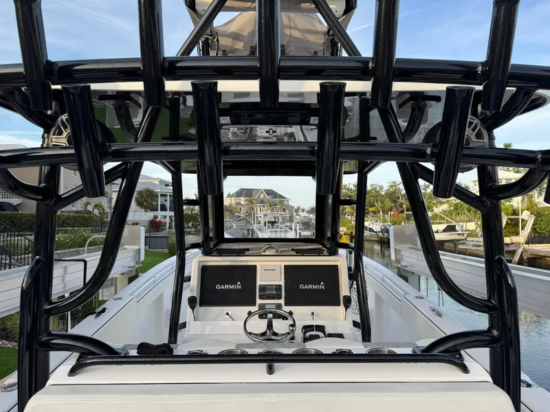 Slide: The Image of 2023 Invincible 33 Catamaran with Garmin displays, docked in a scenic marina. - 7