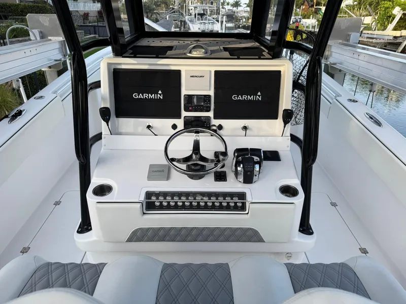 Slide: The Image of 2023 Invincible 33 Catamaran helm with dual Garmin displays and modern controls. - 8
