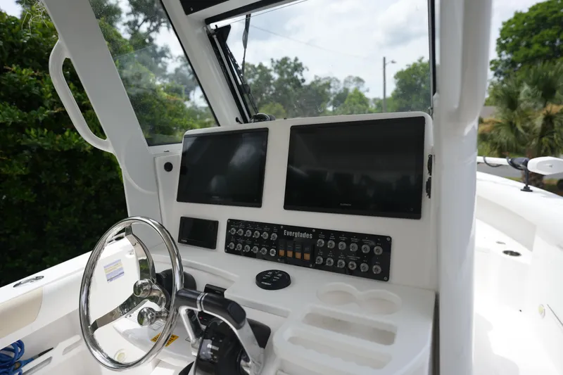 Slide: The Image of Control panel of a 2017 Everglades 255 boat with dual screens and steering wheel. - 5