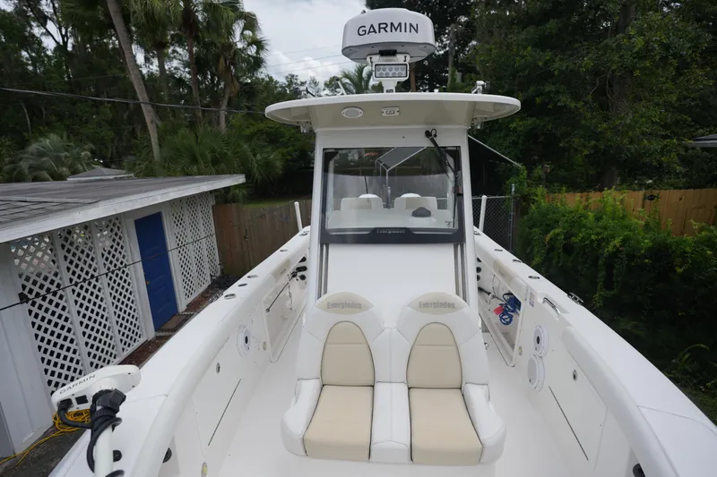Slide: The Image of 2017 Everglades 255 boat with Garmin equipment, docked near greenery and a white fence. - 6