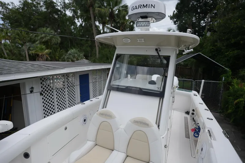 Slide: The Image of 2017 Everglades 255 boat with Garmin equipment, docked near a house. - 7