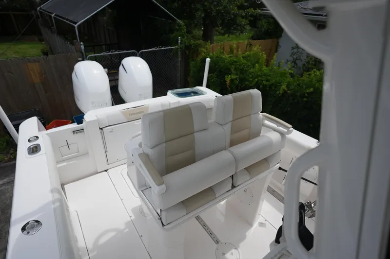 Slide: The Image of 2017 Everglades 255 boat interior with dual engines and cushioned seating. - 8
