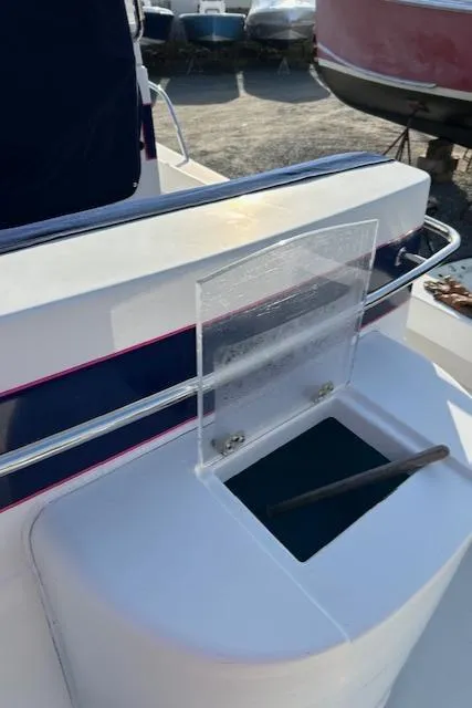 Slide: The Image of 2015 Maritime Skiff 23 Patriot boat with open storage compartment and railing. - 10