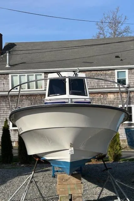 Slide: The Image of 2015 Maritime Skiff 23 Patriot boat on stands, front view, outdoors. - 8