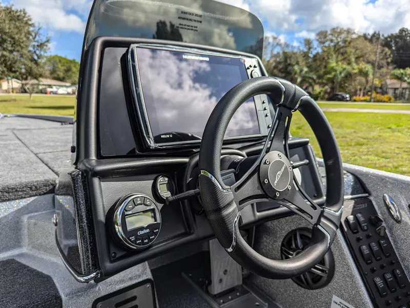 Slide: The Image of Cockpit of 2025 Falcon F20 PREDATOR boat with steering wheel and navigation display. - 11