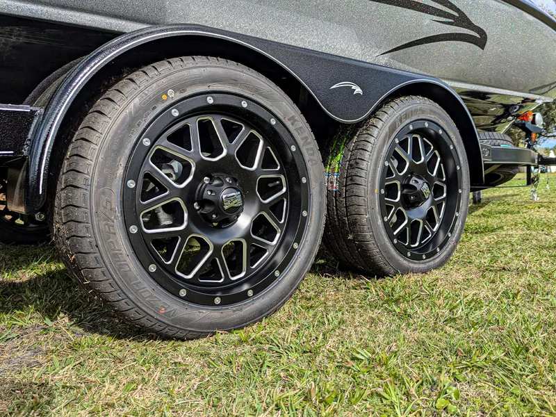 Slide: The Image of Sleek black wheels of a 2025 Falcon F20 PREDATOR on grass. - 6