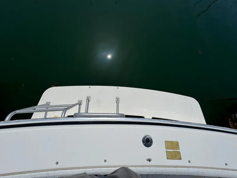 Slide: The Image of 1988 Bertram 28 Sport Fisherman boat stern view with water reflection. - 16