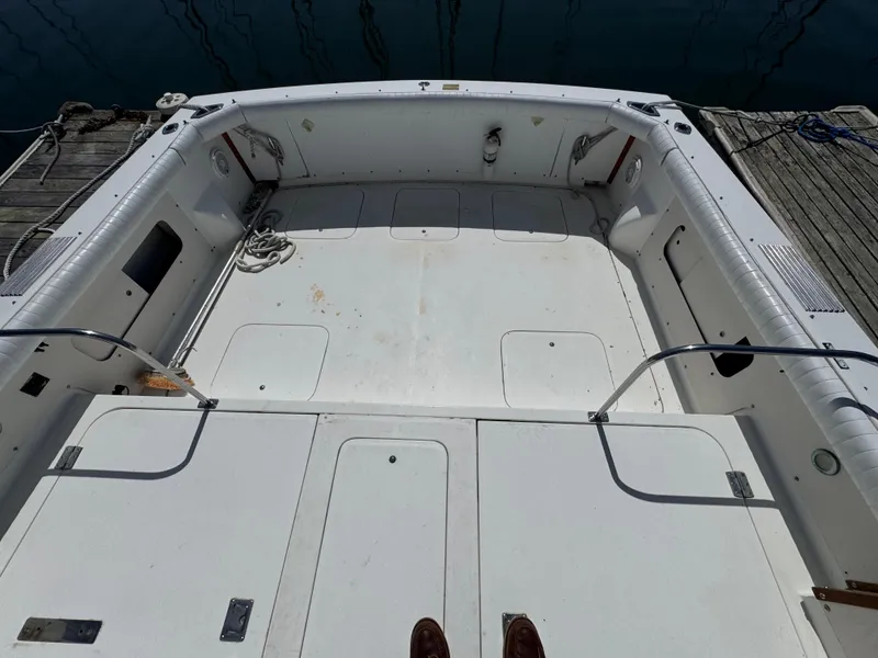 Slide: The Image of 1988 Bertram 28 Sport Fisherman boat deck, spacious and clean, docked by the water. - 17