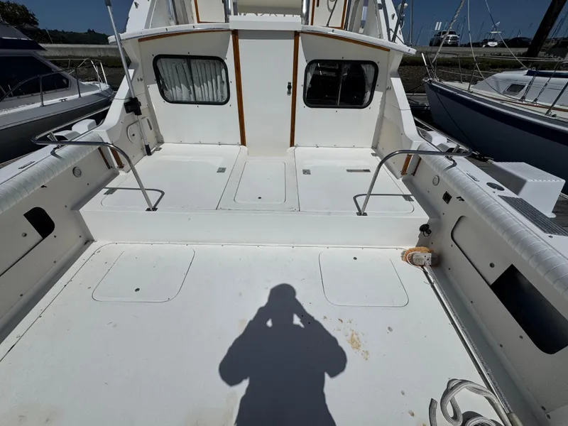 Slide: The Image of 1988 Bertram 28 Sport Fisherman boat deck with railing and shadow. - 18
