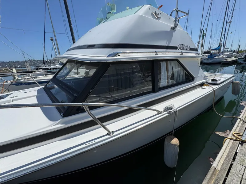 Slide: The Image of 1988 Bertram 28 Sport Fisherman docked at marina, side view. - 21