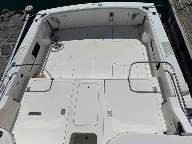 Slide: The Image of 1988 Bertram 28 Sport Fisherman boat deck, spacious and clean, docked at marina. - 3