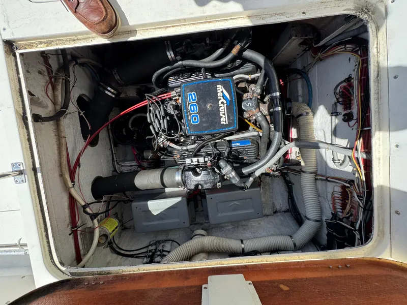 Slide: The Image of Engine compartment of a 1988 Bertram 28 Sport Fisherman boat, featuring a MerCruiser 260 engine. - 5