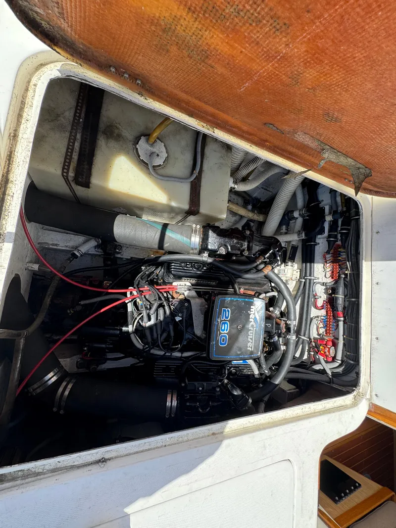 Slide: The Image of 1988 Bertram 28 Sport Fisherman engine compartment with visible components and wiring. - 6