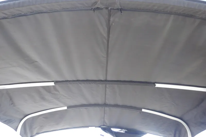 Slide: The Image of 2021 Sylvan Mirage 820 LZ boat canopy, featuring a sturdy, dark fabric cover. - 13