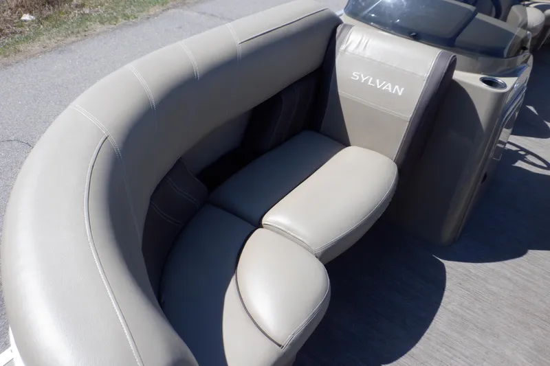 Slide: The Image of 2021 Sylvan Mirage 820 LZ boat seating with beige upholstery and curved design. - 14
