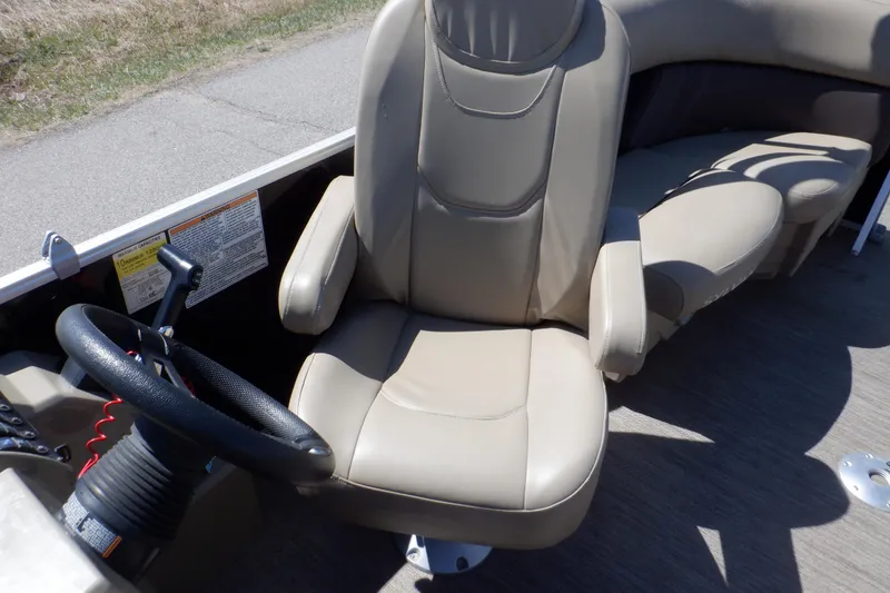 Slide: The Image of 2021 Sylvan Mirage 820 LZ boat interior with beige captain's chair and steering wheel. - 18
