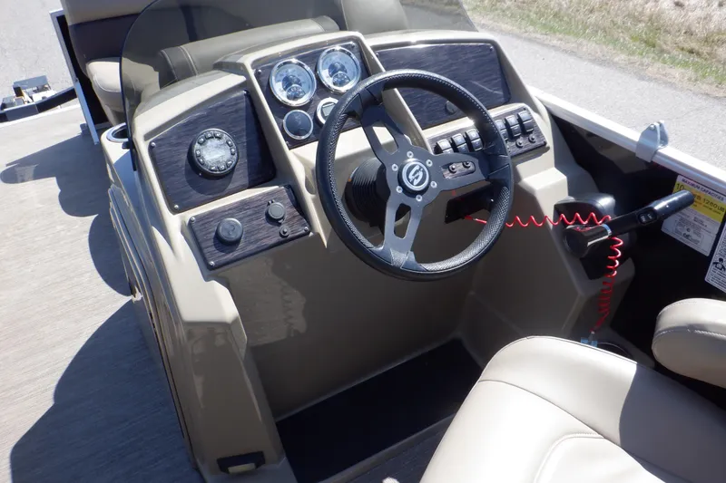 Slide: The Image of 2021 Sylvan Mirage 820 LZ boat dashboard with steering wheel and control panel. - 24