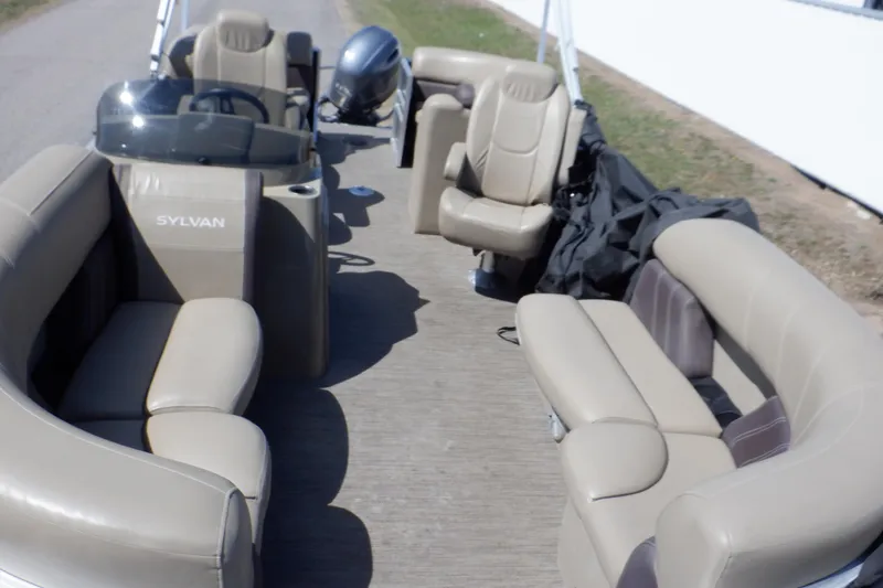Slide: The Image of 2021 Sylvan Mirage 820 LZ pontoon boat with beige seating and steering console. - 3