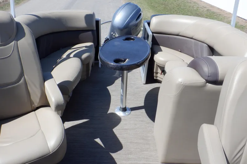 Slide: The Image of 2021 Sylvan Mirage 820 LZ boat interior with beige seating and a central table. - 35