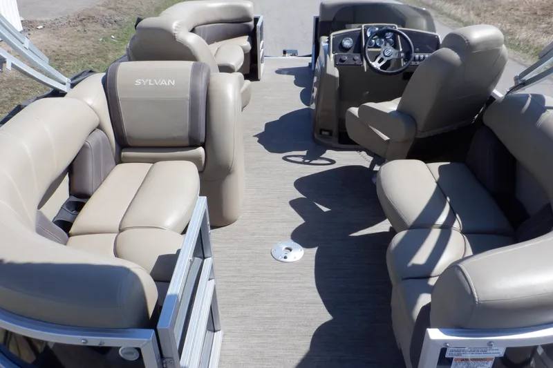 Slide: The Image of 2021 Sylvan Mirage 820 LZ pontoon boat interior with beige seating and steering console. - 4