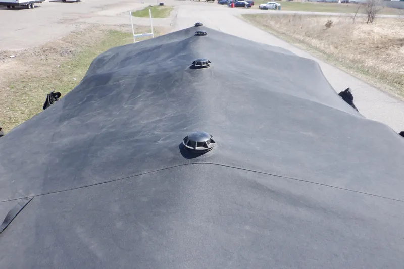 Slide: The Image of 2021 Sylvan Mirage 820 LZ boat with protective cover on a road. - 47