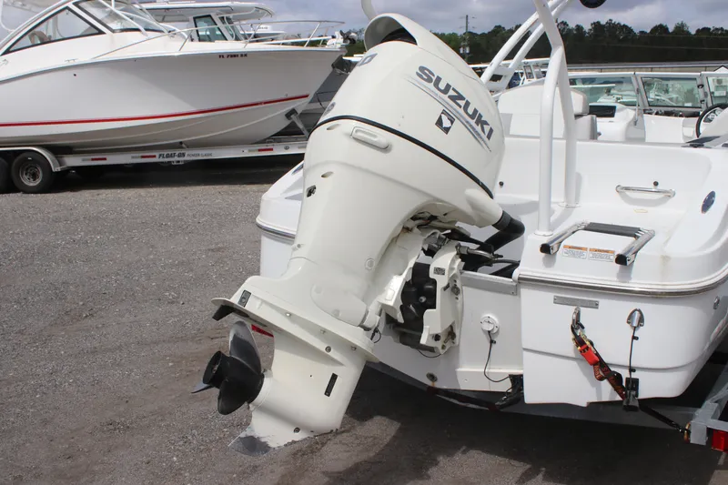 Slide: The Image of 2020 Caravelle 19 EBo Bowrider with Suzuki outboard motor in a boatyard. - 2