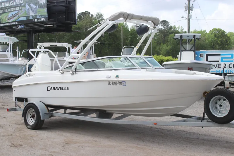 Slide: The Image of 2020 Caravelle 19 EBo Bowrider on trailer, parked outdoors, side view. - 5