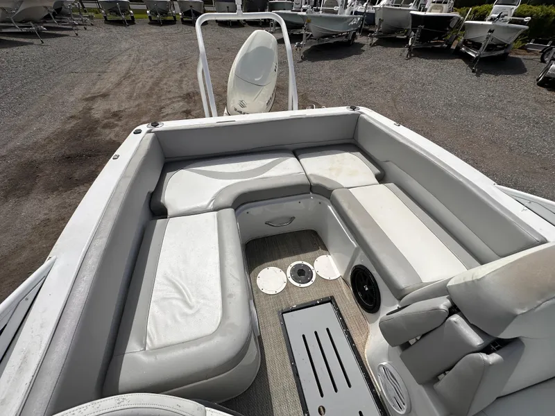 Slide: The Image of 2020 Caravelle 19 EBo Bowrider interior with gray seating and storage compartments. - 6