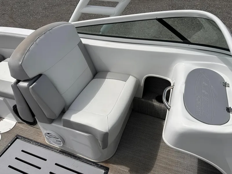 Slide: The Image of 2020 Caravelle 19 EBo Bowrider interior with white seating and storage compartment. - 7