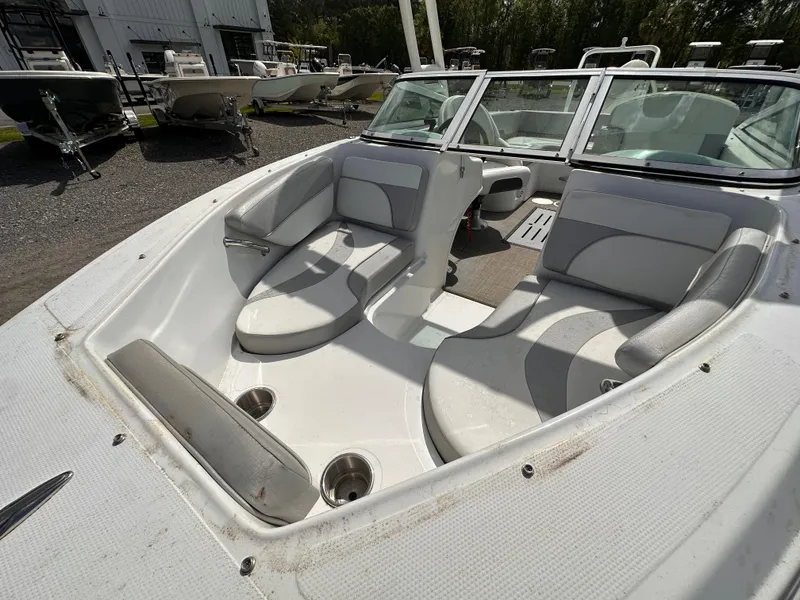 Slide: The Image of 2020 Caravelle 19 EBo Bowrider boat interior with white seating and cup holders. - 9