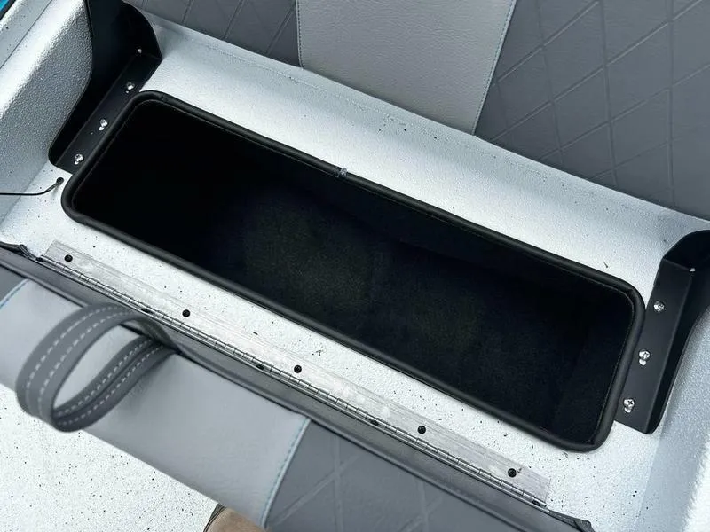 Slide: The Image of 2025 Xpress X23B Lounge boat seat storage compartment, open and empty. - 16