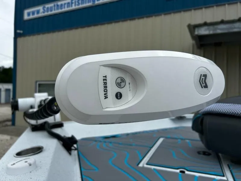 Slide: The Image of 2025 Xpress X23B Lounge boat with Terrova trolling motor, Southern Fishing building in background. - 17