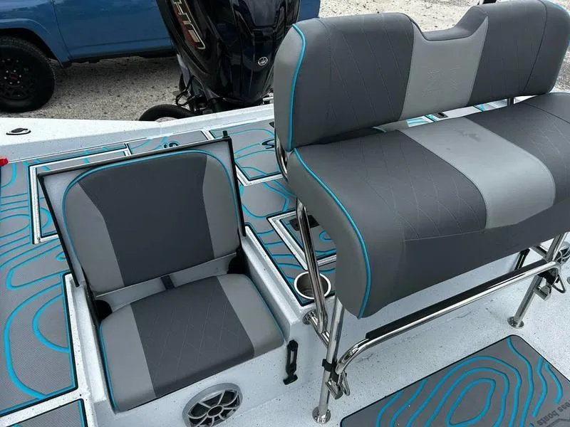 Slide: The Image of 2025 Xpress X23B Lounge boat seats with modern design and blue accents. - 20
