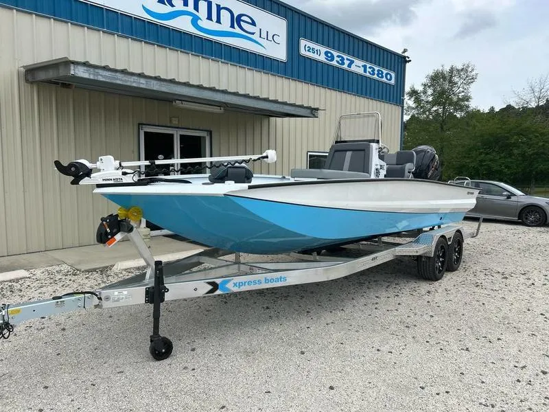 Slide: The Image of 2025 Xpress X23B Lounge boat on trailer outside a marine dealership. - 5
