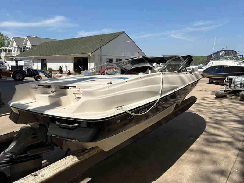 Slide: The Image of 2005 Regal 1800 Bowrider boat on trailer at marina, sunny day. - 2