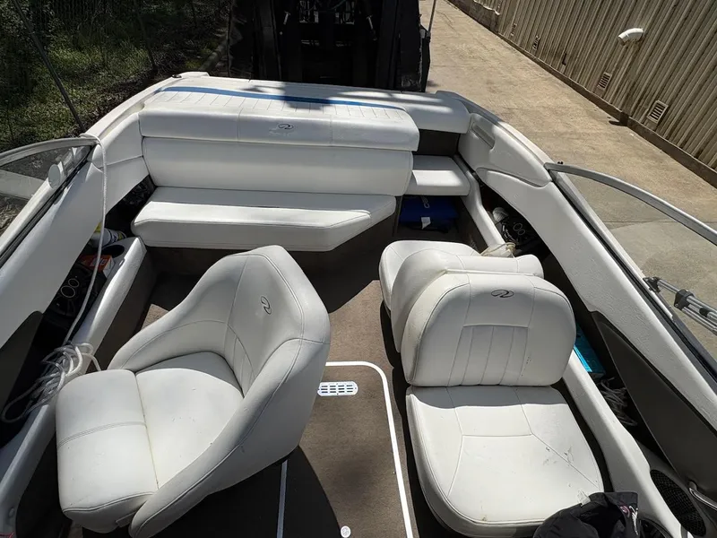 Slide: The Image of 2005 Regal 1800 Bowrider interior with white seating and spacious layout. - 3